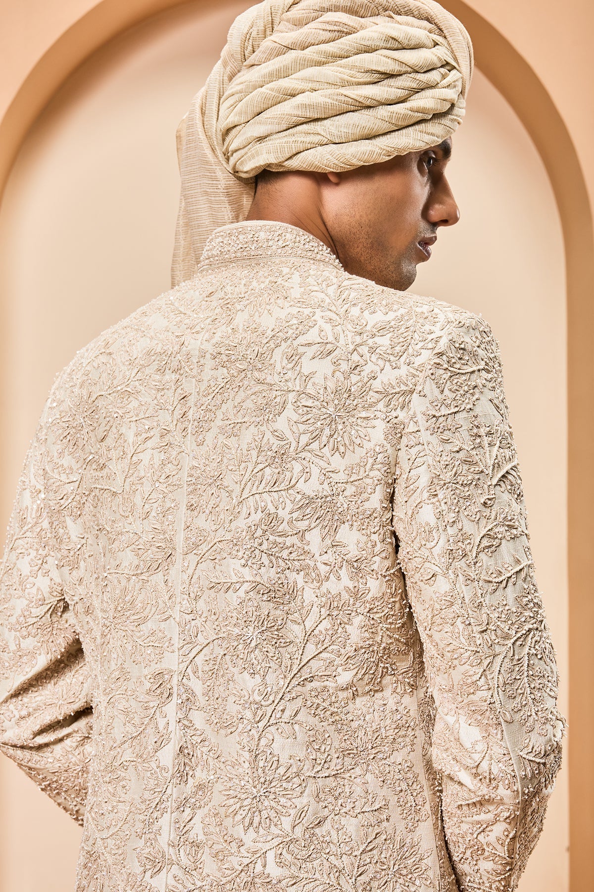 Ivory sherwani detailing with gold zari pearl sequins and spring work