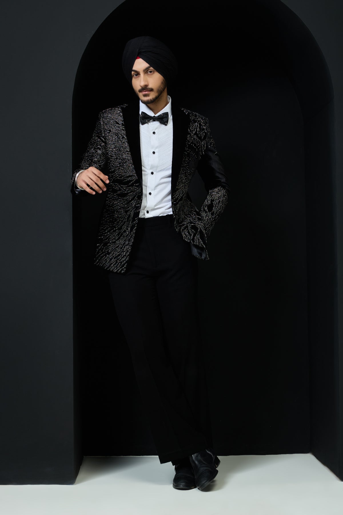 Black tuxedo highlighted with silver zari and peals