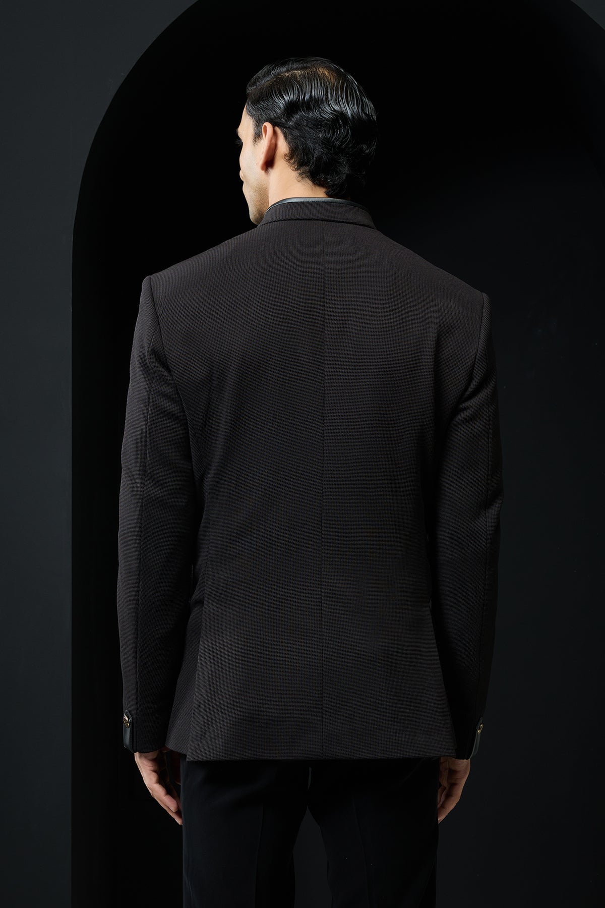 Black bandhgala with slant cut detailing with golden button and with satin taping