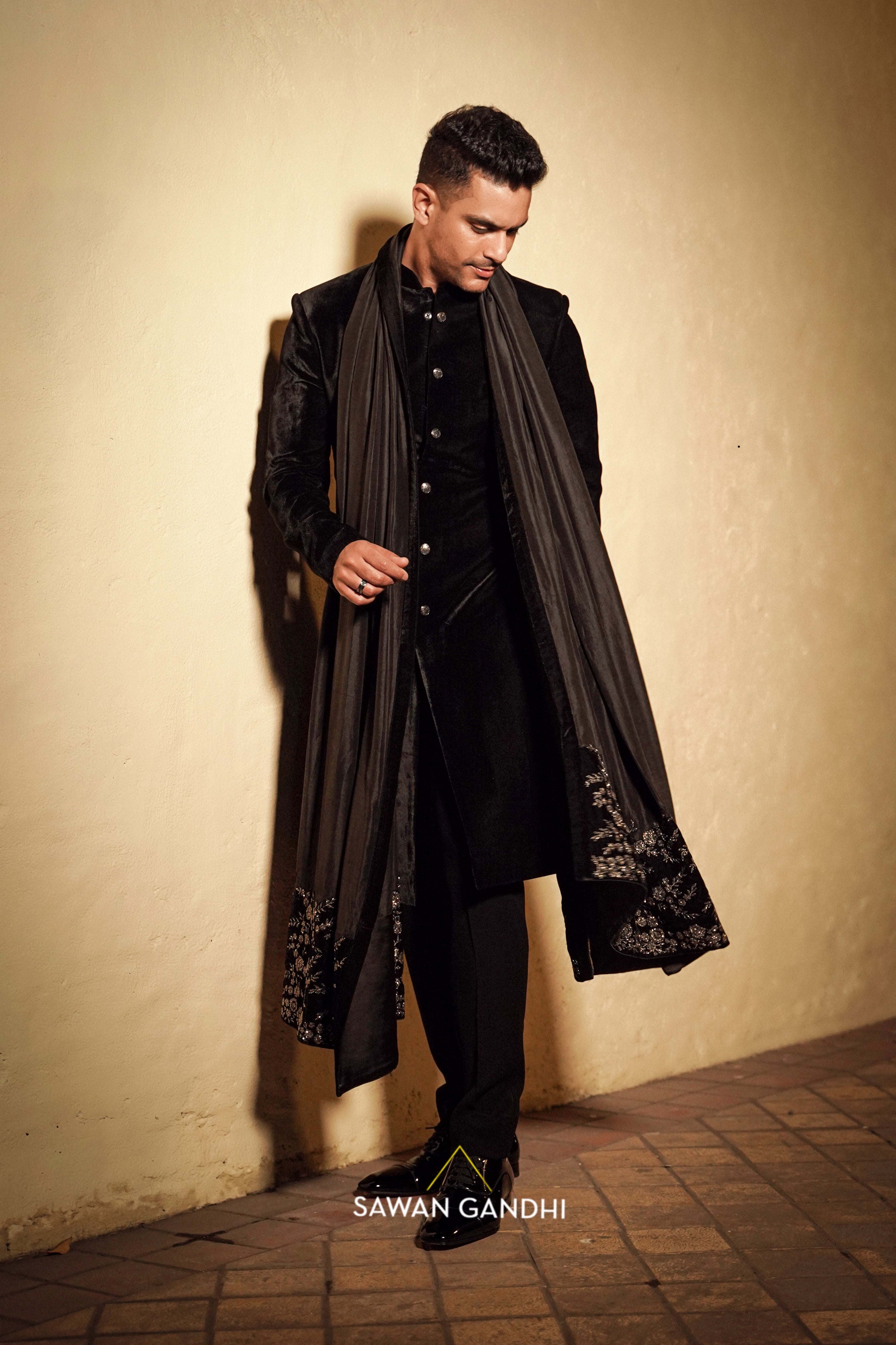 Angad bedi in Black velvet sherwani with tuape black stole