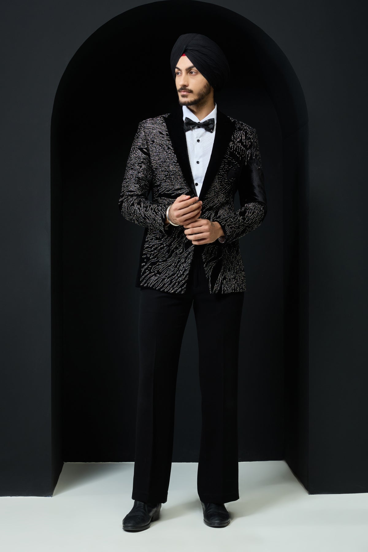 Black tuxedo highlighted with silver zari and peals