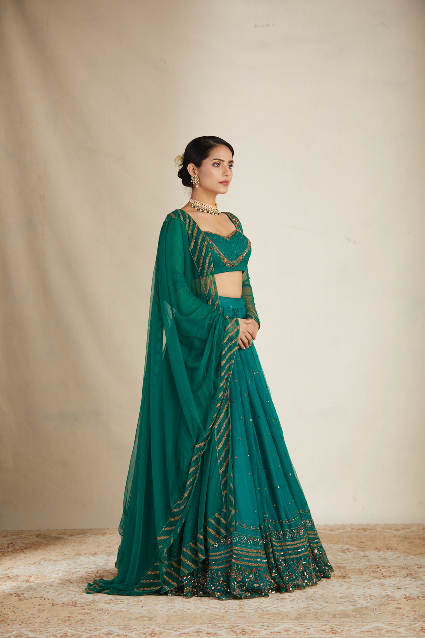 TEAL GREEN ANTIQUE SEQUENCE WORK LEHENGA SET