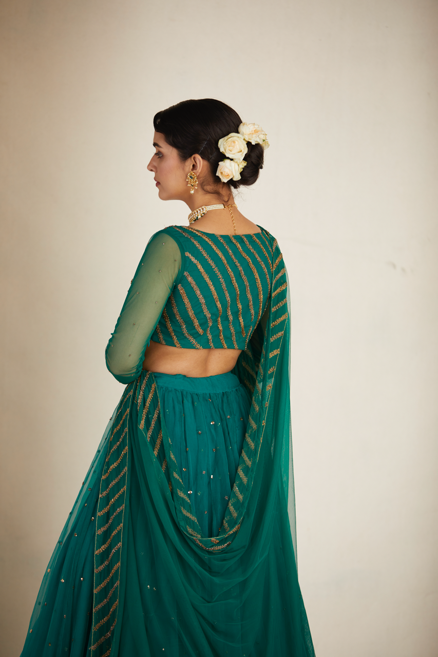 TEAL GREEN ANTIQUE SEQUENCE WORK LEHENGA SET