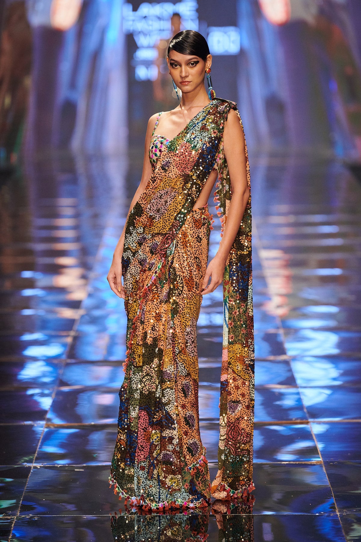 Right side view of sequinned saree and embellished blouse.
